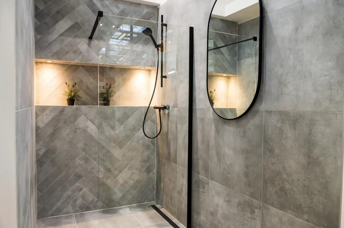 Modern walk-in shower with frameless glass and tiled walls — Nova Havens furnished home